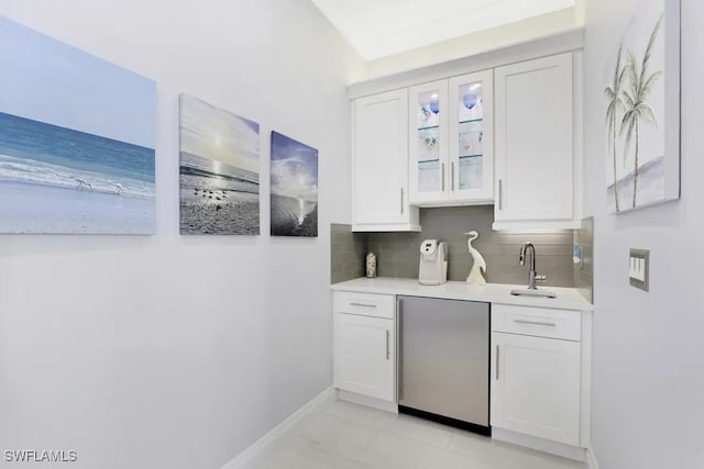 140 Seaview Ct Unit 103N, Marco Island, FL 34145 - bar featuring fridge, baseboards, a sink, and tasteful backsplash