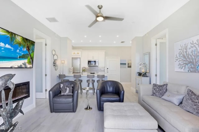 140 Seaview Ct Unit 103N, Marco Island, FL 34145 - living area featuring light wood-type flooring, a ceiling fan, baseboards, and visible vents
