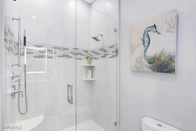 140 Seaview Ct Unit 103N, Marco Island, FL 34145 - bathroom featuring toilet and a shower stall