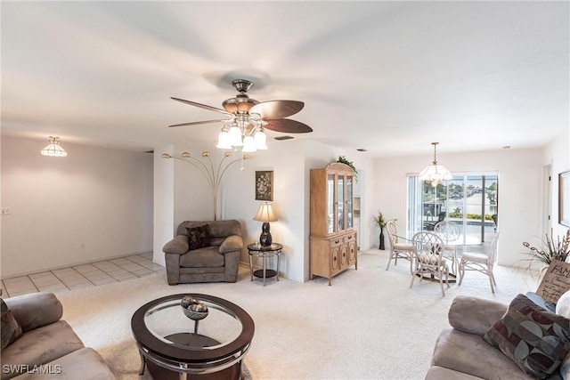 living area featuring light carpet and a ceiling fan