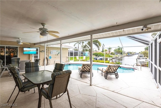 exterior space featuring glass enclosure, a patio, and ceiling fan