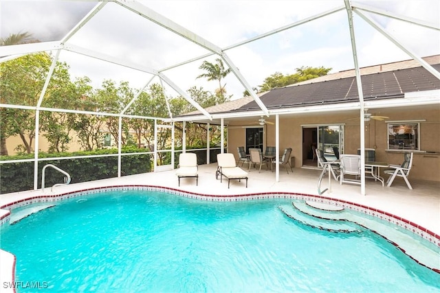 outdoor pool featuring ceiling fan, glass enclosure, a patio area, and outdoor dining space