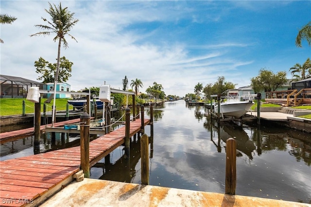 view of dock with boat lift and a water view
