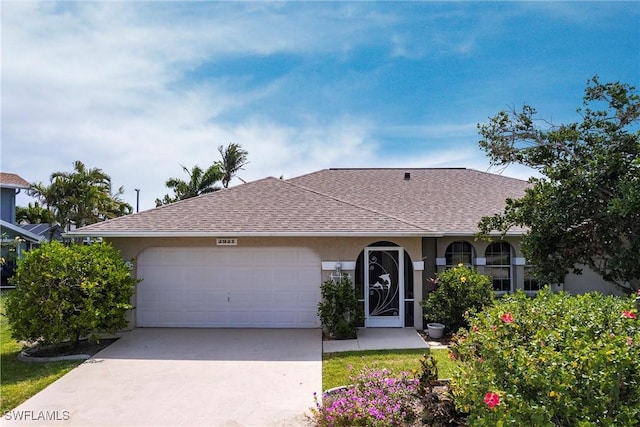 single story home featuring concrete driveway, an attached garage, roof with shingles, and stucco siding