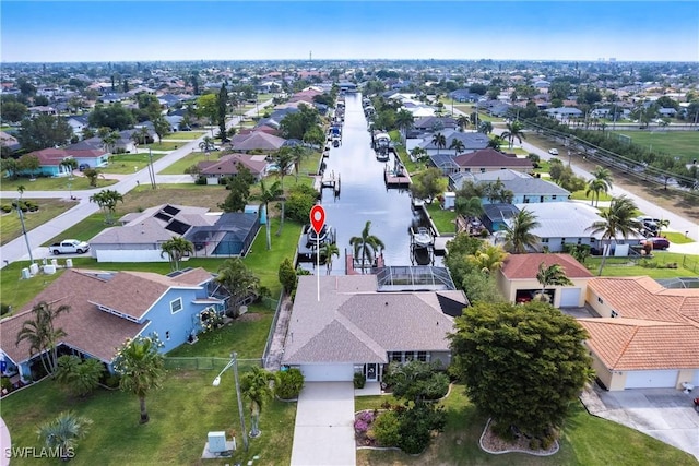 bird's eye view featuring a water view and a residential view