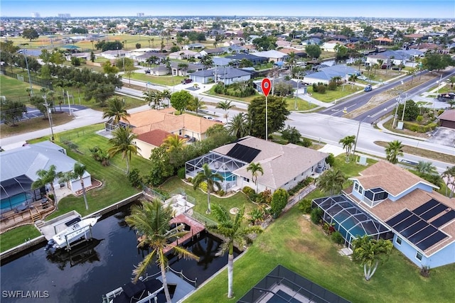 birds eye view of property with a residential view and a water view