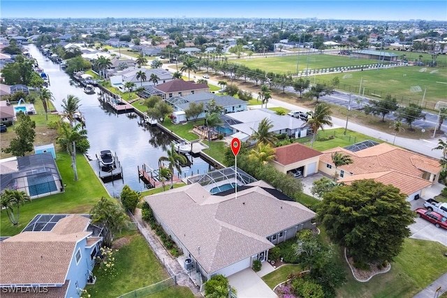 drone / aerial view featuring a residential view and a water view
