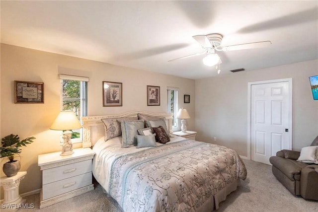 bedroom featuring a ceiling fan, visible vents, and carpet floors