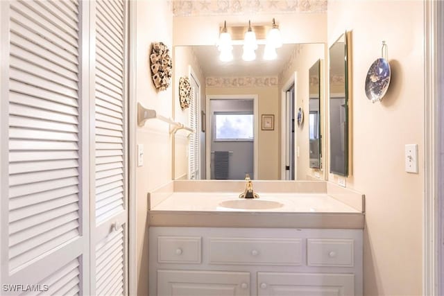bathroom with vanity and a chandelier