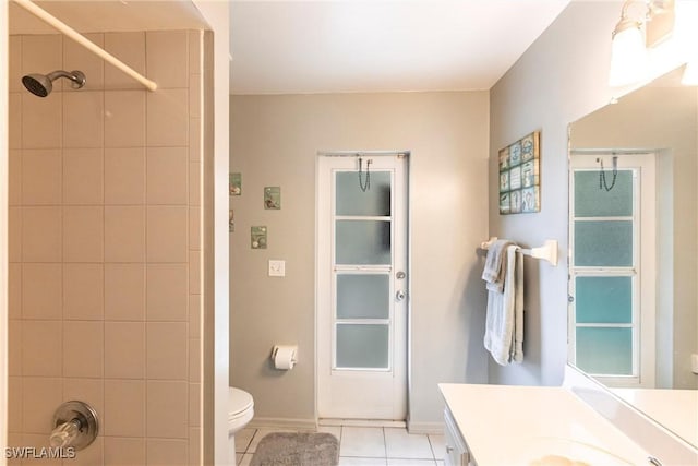 bathroom with vanity, tile patterned flooring, a shower, and toilet