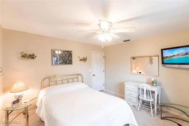 carpeted bedroom with visible vents, baseboards, and ceiling fan
