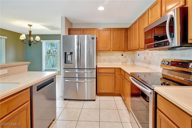 kitchen featuring an inviting chandelier, light countertops, and stainless steel appliances