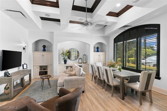 dining area with arched walkways, light wood-style flooring, visible vents, and coffered ceiling