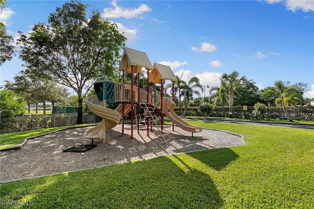 communal playground with fence and a yard