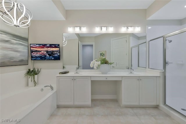 bathroom featuring a sink, a chandelier, and a shower stall