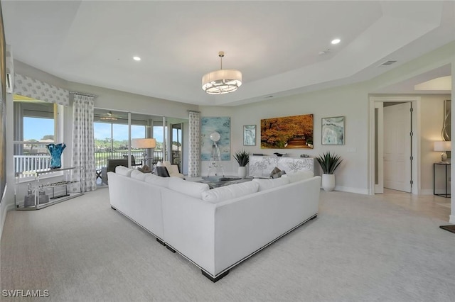 living area featuring recessed lighting, baseboards, light colored carpet, and a chandelier