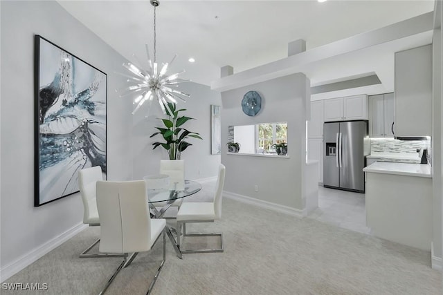 dining room featuring baseboards, light colored carpet, recessed lighting, and a chandelier