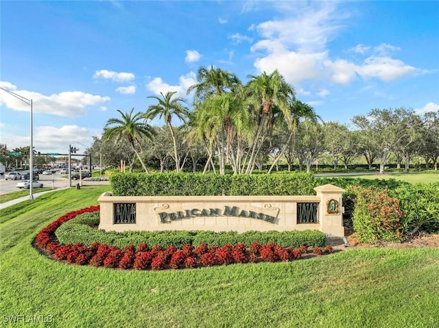 community sign featuring a yard
