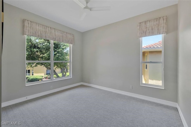 empty room with baseboards, carpet, and a ceiling fan
