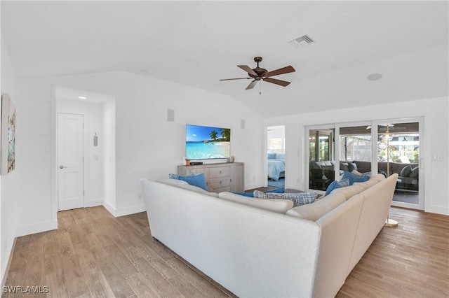 living area with light wood-style floors, ceiling fan, baseboards, lofted ceiling, and visible vents