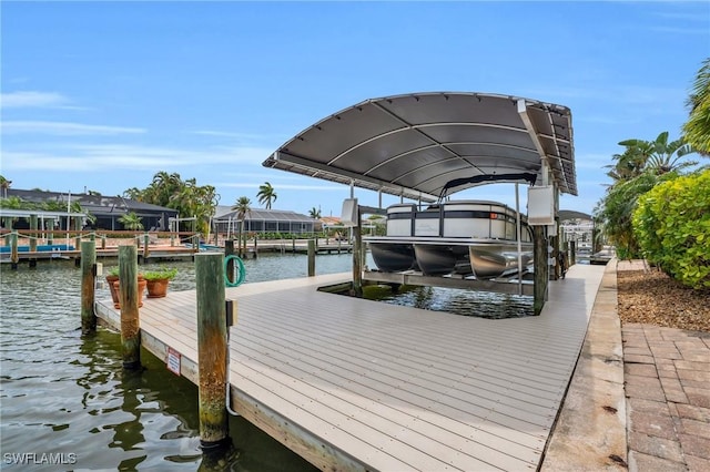 dock area with boat lift and a water view