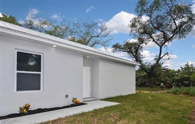 4637 Elvas Ave S, Fort Myers, FL 33905 - entrance to property featuring stucco siding and a lawn