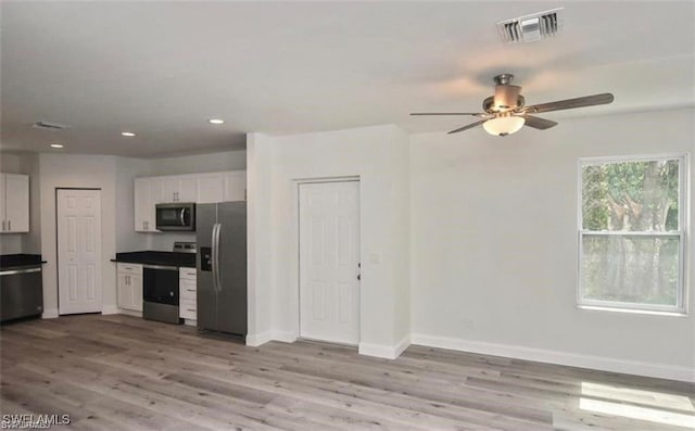 4637 Elvas Ave S, Fort Myers, FL 33905 - kitchen featuring appliances with stainless steel finishes, wood finished floors, ceiling fan, baseboards, and white cabinets