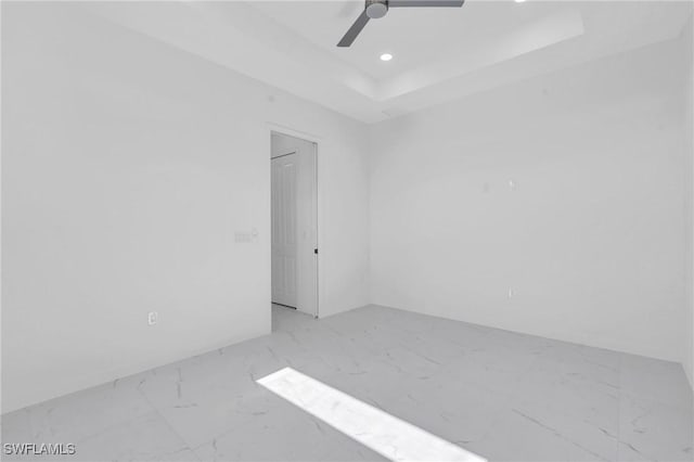 3101 NW 42nd Pl, Cape Coral, FL 33993 - spare room featuring marble finish floors, a ceiling fan, recessed lighting, and a tray ceiling