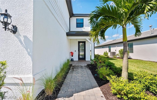 20250 Napa Loop, Estero, FL 33928 - view of exterior entry featuring cooling unit and stucco siding