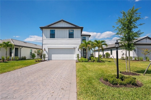 20250 Napa Loop, Estero, FL 33928 - traditional-style house featuring a front lawn, stucco siding, an attached garage, board and batten siding, and decorative driveway