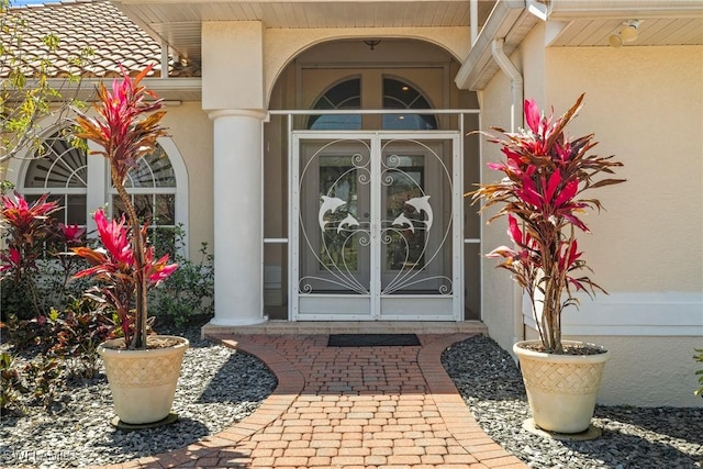 2817 La Mancha Ct, Punta Gorda, FL 33950 - property entrance with stucco siding and french doors