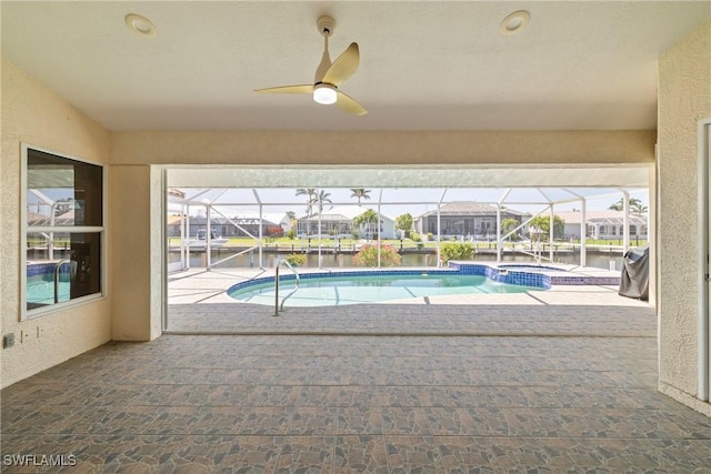 2817 La Mancha Ct, Punta Gorda, FL 33950 - view of pool featuring a patio area, a pool with connected hot tub, a ceiling fan, and a water view