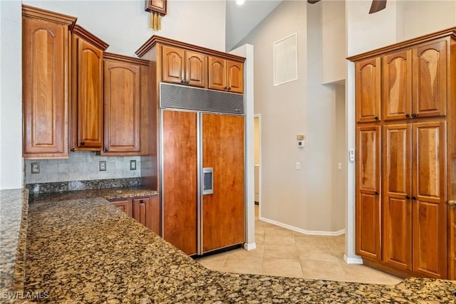 2817 La Mancha Ct, Punta Gorda, FL 33950 - kitchen featuring paneled built in fridge, tasteful backsplash, light tile patterned flooring, and brown cabinets