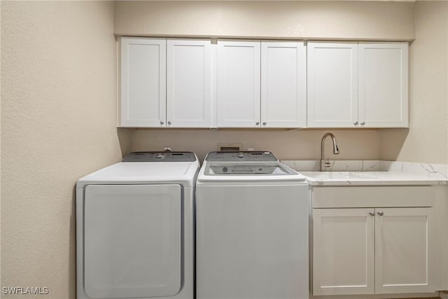 2817 La Mancha Ct, Punta Gorda, FL 33950 - washroom featuring cabinet space, separate washer and dryer, and a textured wall