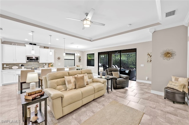14482 Tuscany Pointe Trl, Naples, FL 34120 - living area with ceiling fan, visible vents, crown molding, baseboards, and a raised ceiling