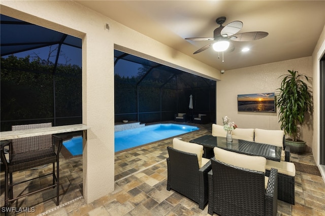 14482 Tuscany Pointe Trl, Naples, FL 34120 - pool featuring outdoor dining area, glass enclosure, ceiling fan, and a patio area