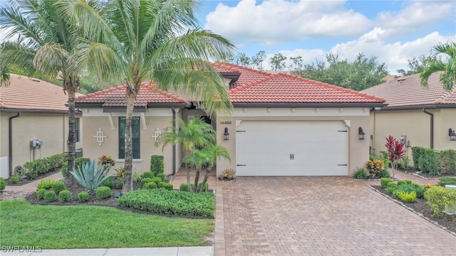 14482 Tuscany Pointe Trl, Naples, FL 34120 - mediterranean / spanish-style house featuring stucco siding, a tiled roof, an attached garage, and decorative driveway