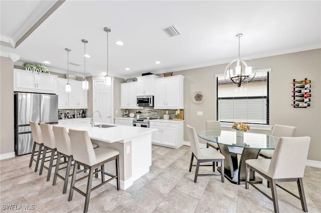 14482 Tuscany Pointe Trl, Naples, FL 34120 - kitchen featuring appliances with stainless steel finishes, ornamental molding, backsplash, a chandelier, and a kitchen breakfast bar
