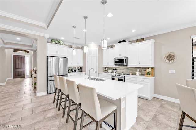14482 Tuscany Pointe Trl, Naples, FL 34120 - kitchen featuring a breakfast bar area, appliances with stainless steel finishes, tasteful backsplash, a sink, and ornamental molding