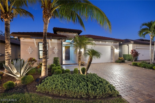 14482 Tuscany Pointe Trl, Naples, FL 34120 - view of front of house featuring a garage, decorative driveway, and stucco siding