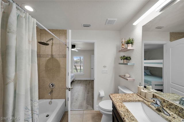 full bathroom featuring shower / tub combo, toilet, tile patterned flooring, vanity, and baseboards