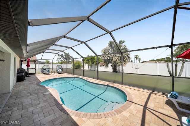 view of pool featuring a patio area, a fenced backyard, and a lanai