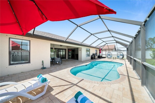 swimming pool featuring a patio and a lanai