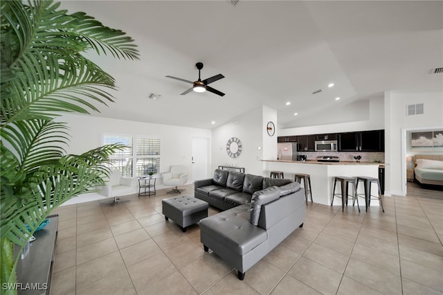 living area featuring vaulted ceiling, light tile patterned floors, ceiling fan, and recessed lighting
