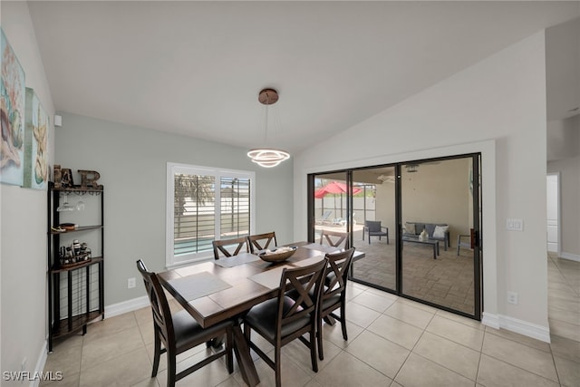 dining area featuring vaulted ceiling, light tile patterned flooring, and baseboards