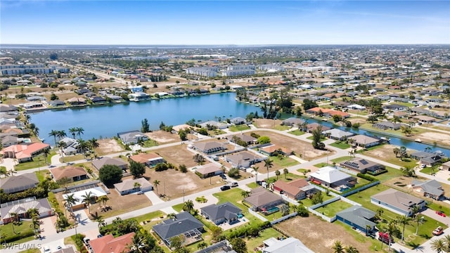 aerial view of property's location with nearby suburban area and a nearby body of water