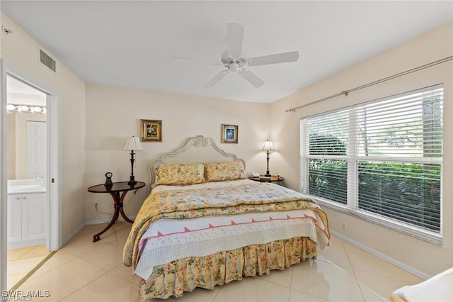 5045 Cedar Springs Dr Unit 104, Naples, FL 34110 - bedroom featuring visible vents, a ceiling fan, light tile patterned floors, baseboards, and ensuite bathroom