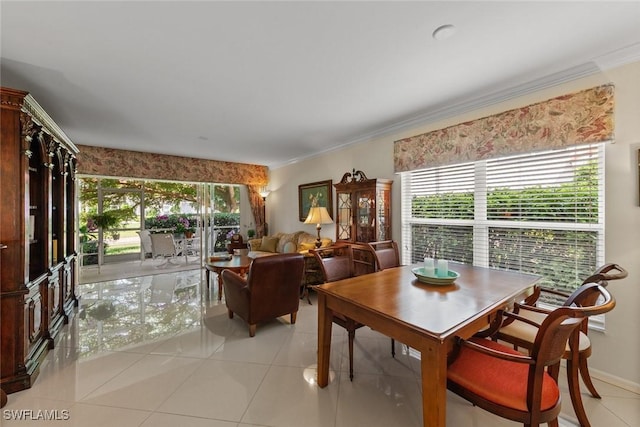 5045 Cedar Springs Dr Unit 104, Naples, FL 34110 - dining area with ornamental molding and light tile patterned floors