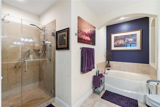 1259 Carpazi Ct Unit 302, Naples, FL 34105 - bathroom with a garden tub, a stall shower, tile patterned flooring, and baseboards