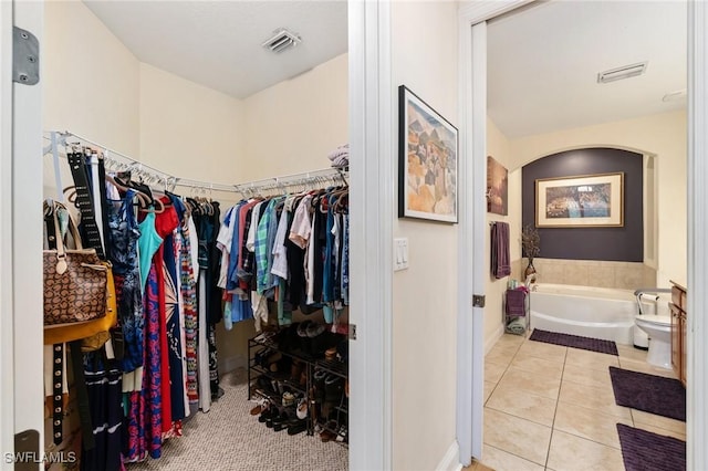 1259 Carpazi Ct Unit 302, Naples, FL 34105 - spacious closet with tile patterned floors, visible vents, and arched walkways